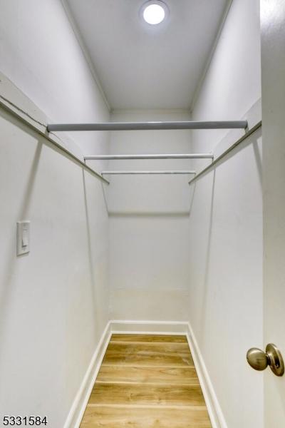 spacious closet featuring hardwood / wood-style flooring