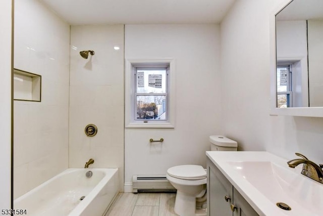 full bathroom with vanity, tiled shower / bath combo, toilet, and baseboard heating