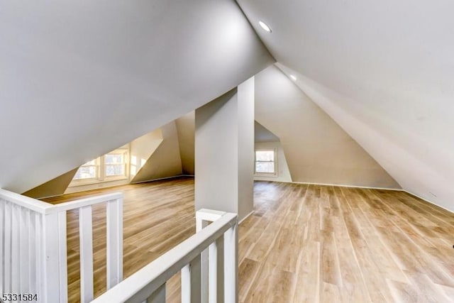 additional living space featuring hardwood / wood-style flooring and lofted ceiling