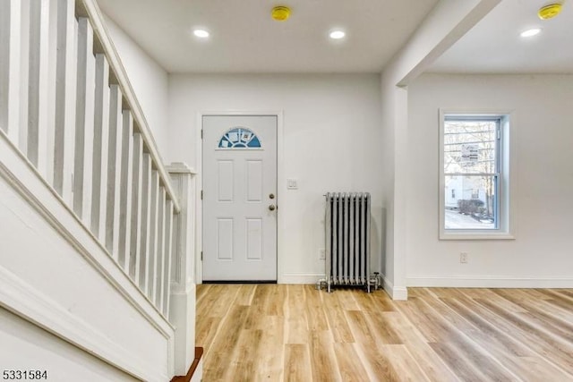 entryway with radiator and light hardwood / wood-style flooring