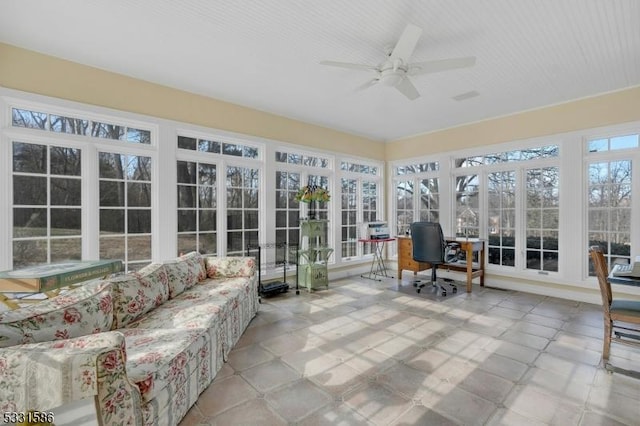 sunroom / solarium featuring ceiling fan