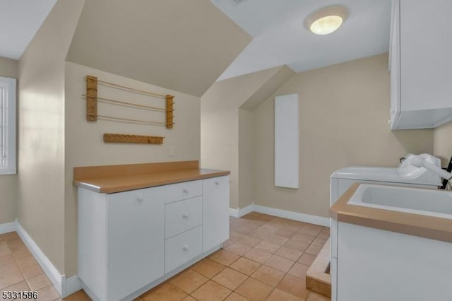 laundry area with light tile patterned floors and sink