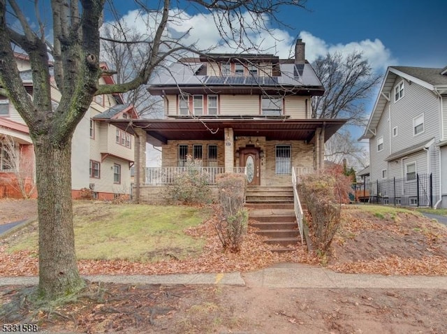 view of front facade with a front lawn and covered porch