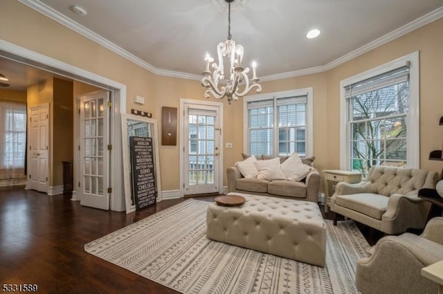 sitting room with ornamental molding, dark hardwood / wood-style flooring, and a notable chandelier