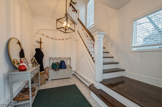 interior space with a baseboard heating unit and an inviting chandelier