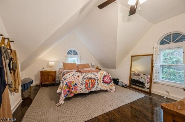 bedroom featuring dark hardwood / wood-style flooring, vaulted ceiling, and ceiling fan