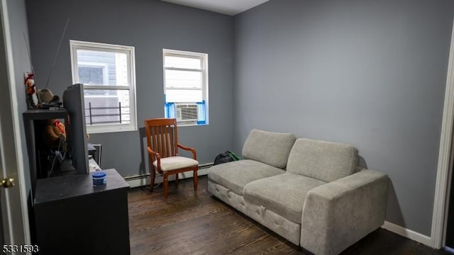 sitting room with dark wood-style flooring, baseboard heating, and baseboards