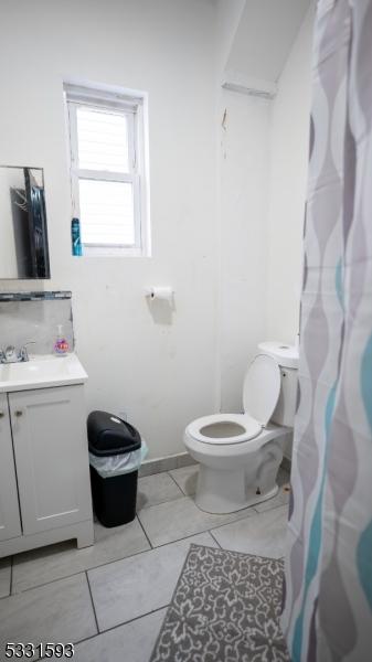 full bath with toilet and vanity