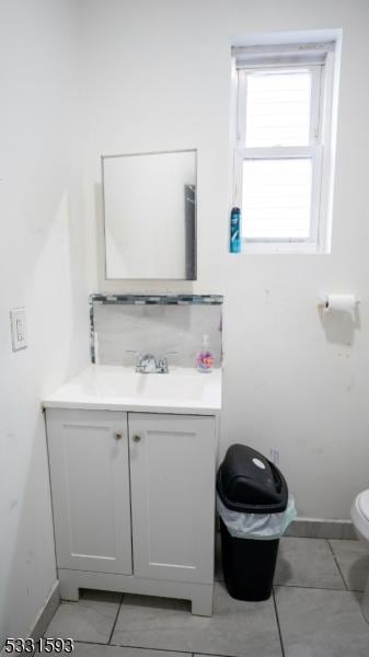 bathroom featuring toilet, tile patterned floors, and vanity