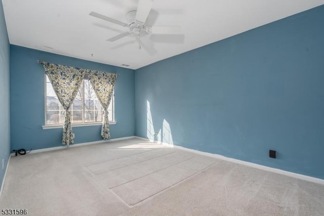 unfurnished room featuring ceiling fan and carpet floors