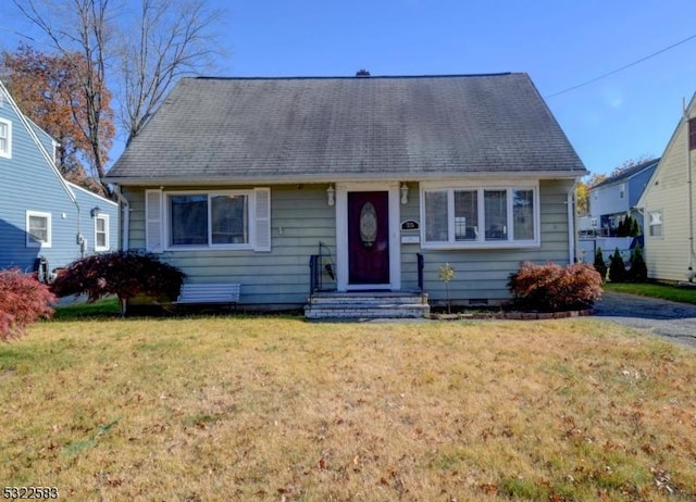 bungalow-style home with a front lawn