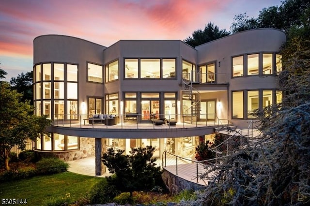 view of back house at dusk