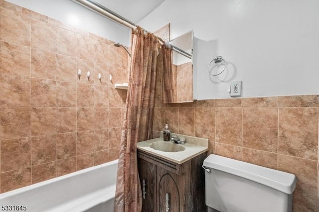 full bathroom with vanity, shower / tub combo, tile walls, and toilet