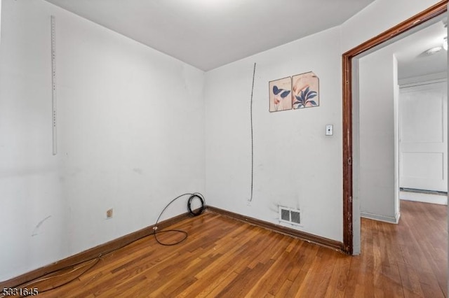 clothes washing area with hardwood / wood-style floors