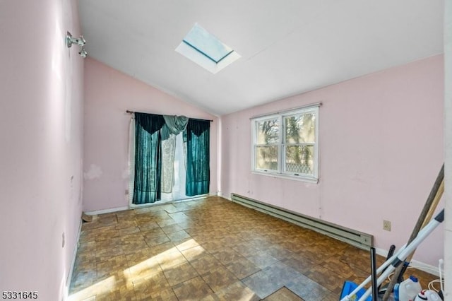 spare room with baseboard heating and vaulted ceiling with skylight