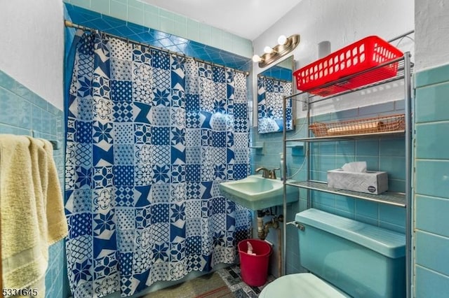 bathroom with toilet and tile walls