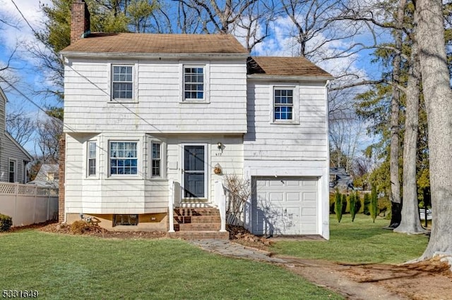 view of front facade with a front yard and a garage