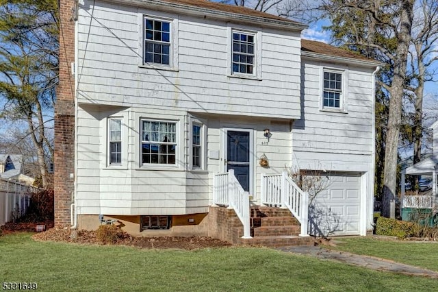 split foyer home with a garage and a front lawn