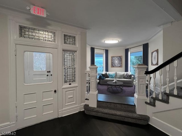 entrance foyer featuring hardwood / wood-style flooring and ornamental molding