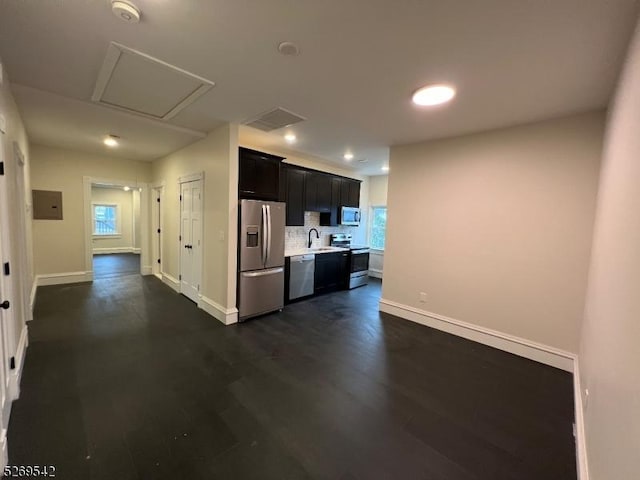 kitchen with sink, stainless steel appliances, tasteful backsplash, dark hardwood / wood-style flooring, and electric panel