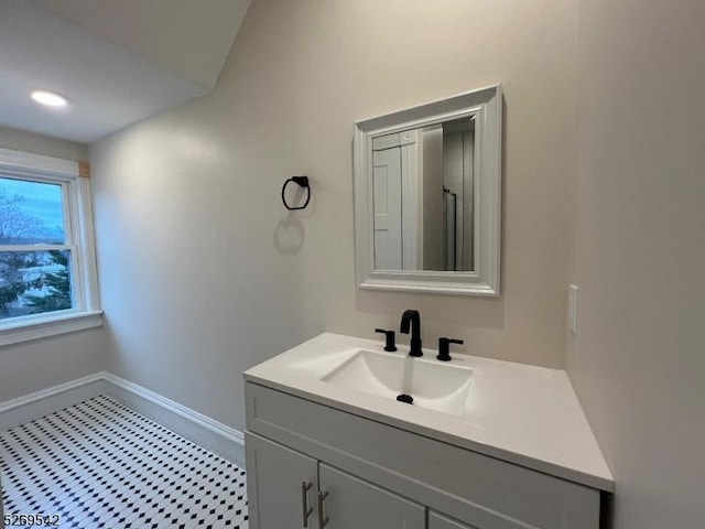 bathroom with vanity and vaulted ceiling