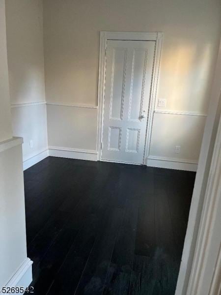 spare room with dark hardwood / wood-style flooring