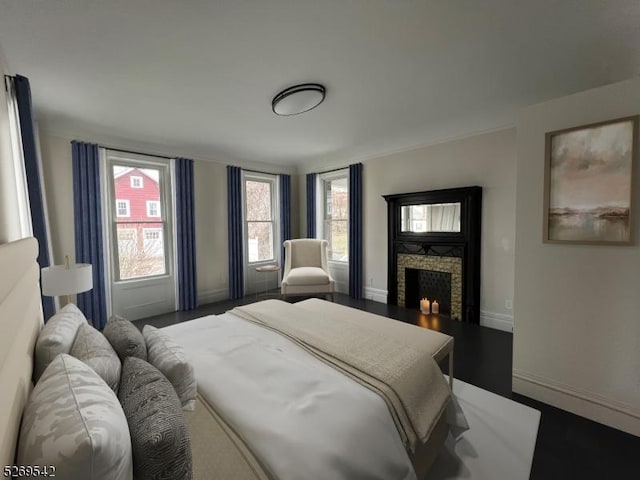 bedroom with a fireplace and hardwood / wood-style floors