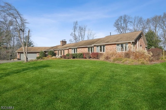 ranch-style home with a garage and a front yard