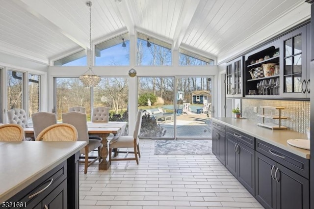 sunroom with vaulted ceiling with beams