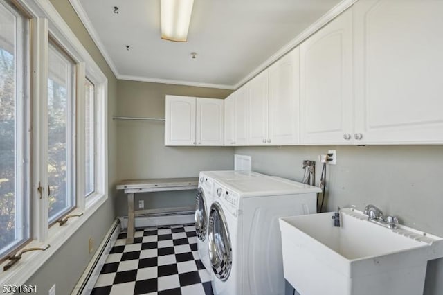 laundry area with cabinets, sink, separate washer and dryer, baseboard heating, and a wealth of natural light