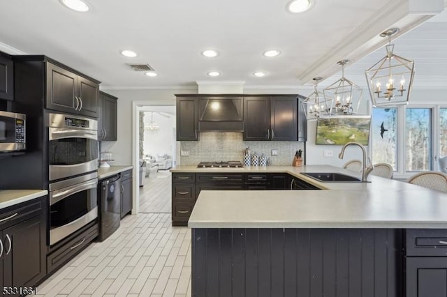 kitchen featuring custom exhaust hood, backsplash, crown molding, sink, and stainless steel appliances