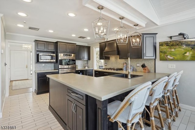 kitchen featuring a kitchen bar, kitchen peninsula, custom range hood, stainless steel appliances, and crown molding