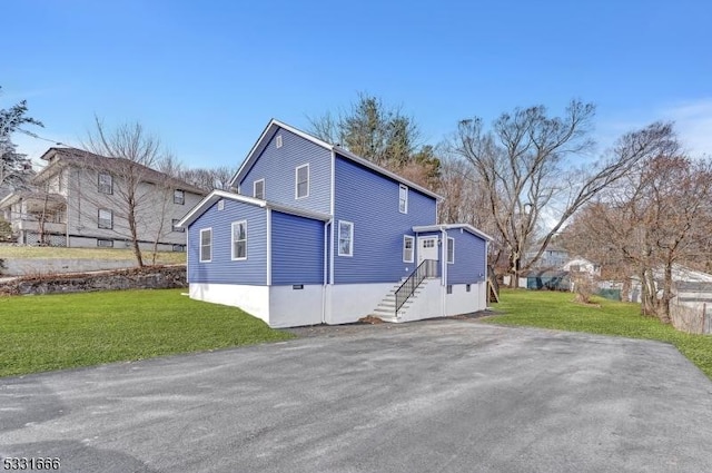 view of side of home with a lawn