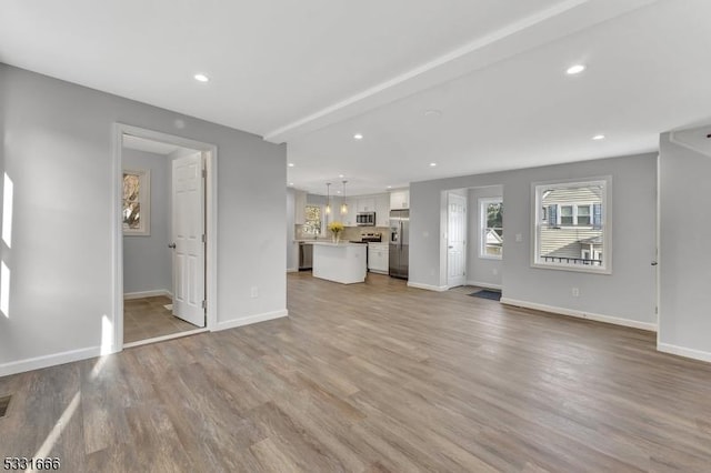 unfurnished living room with light wood-type flooring