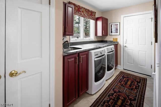 laundry room with light tile patterned flooring, cabinets, separate washer and dryer, and sink