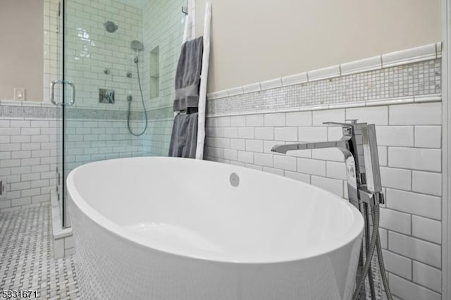 bathroom featuring tile walls, separate shower and tub, and tile patterned flooring