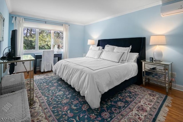 bedroom featuring dark hardwood / wood-style floors, crown molding, and a wall unit AC