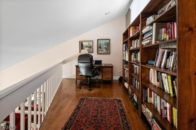 home office featuring vaulted ceiling and dark hardwood / wood-style floors