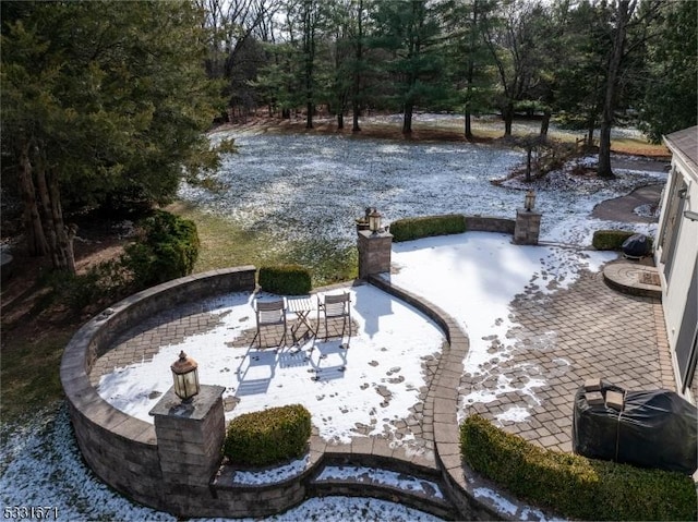 surrounding community with a fire pit and a patio area