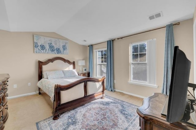 carpeted bedroom with vaulted ceiling