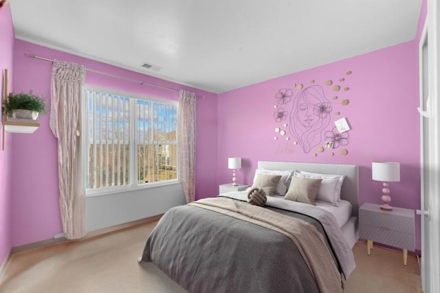 bedroom featuring light carpet