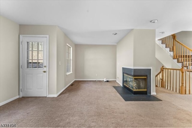 unfurnished living room with dark colored carpet and a multi sided fireplace