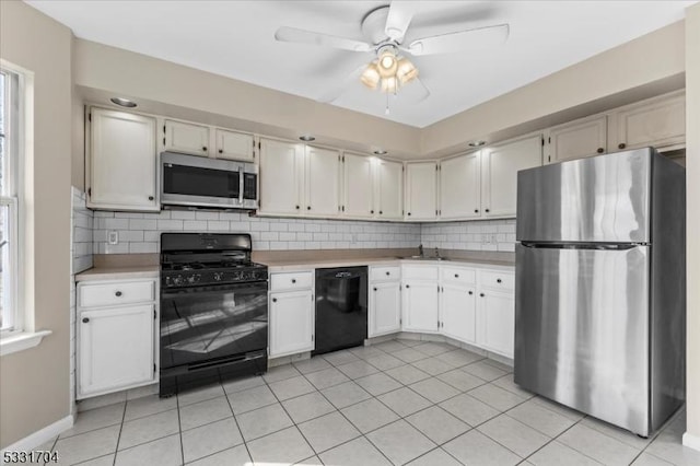 kitchen featuring backsplash, white cabinets, and black appliances