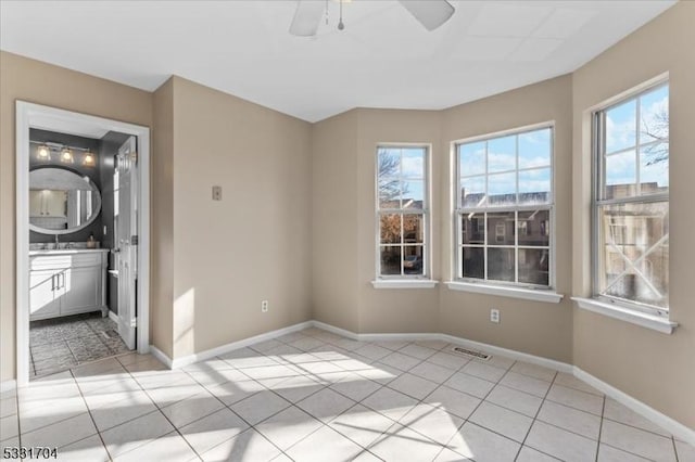 tiled empty room with ceiling fan