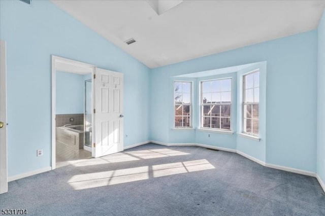 unfurnished bedroom featuring lofted ceiling and carpet floors