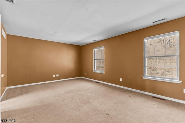 carpeted empty room featuring a healthy amount of sunlight