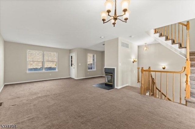 unfurnished living room featuring carpet and a chandelier