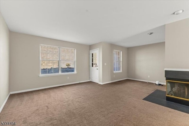 unfurnished living room featuring carpet floors