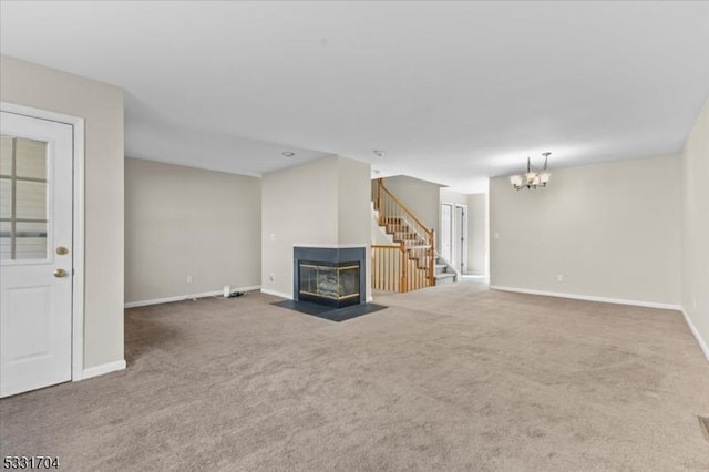 unfurnished living room with carpet floors and a chandelier