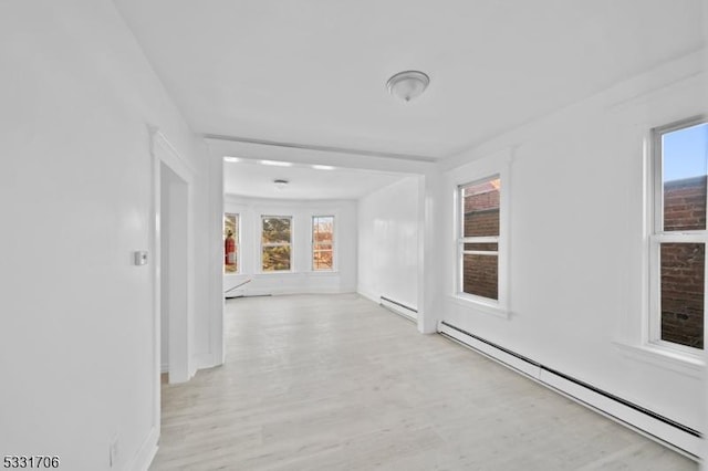 hall featuring baseboard heating and light wood-type flooring